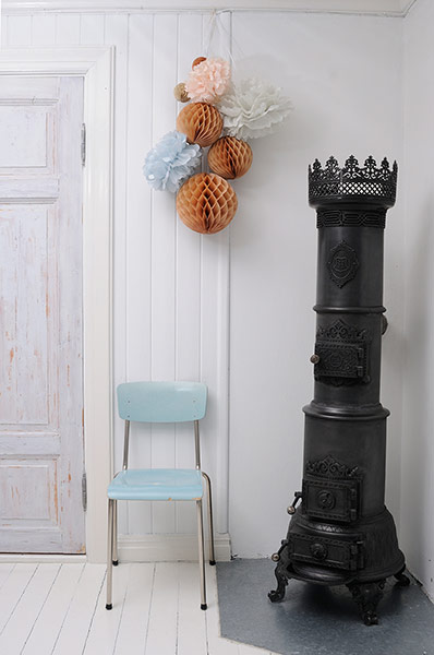 white wall with pastel chair and cast iron oven