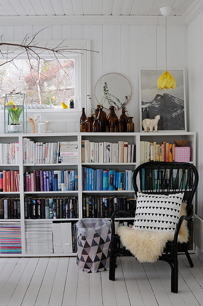 white room with bookshelves and black chair