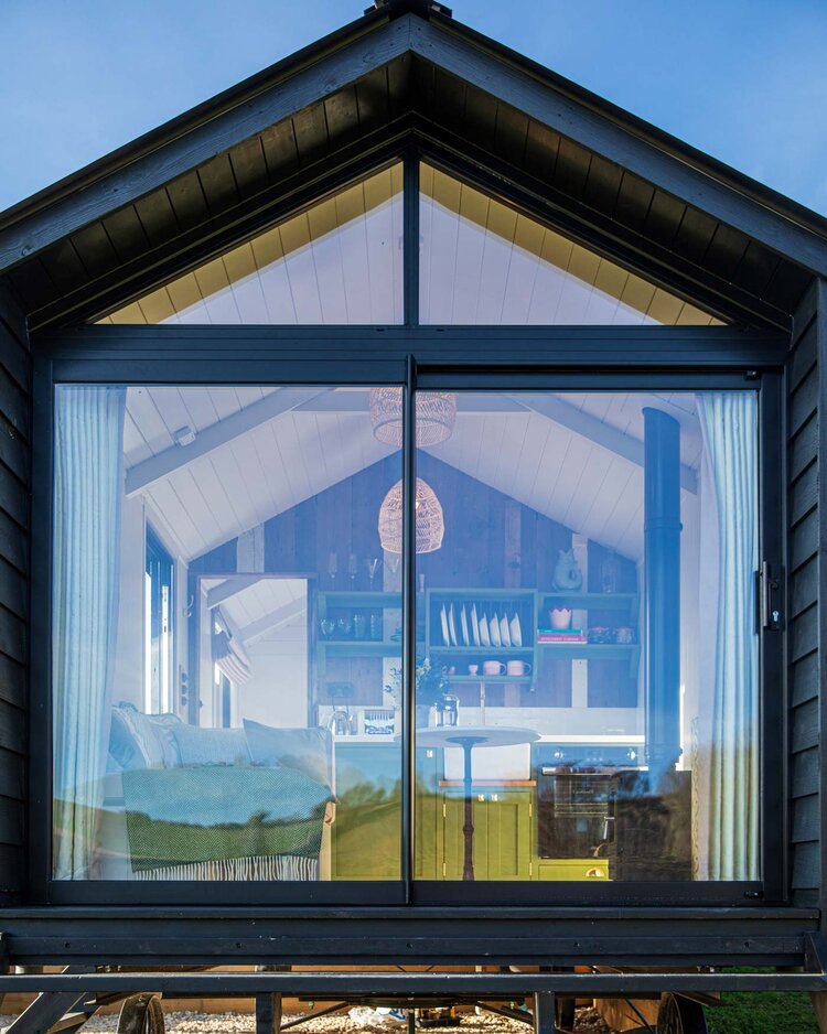 façade vitrée mini maison en bois dans la campagne