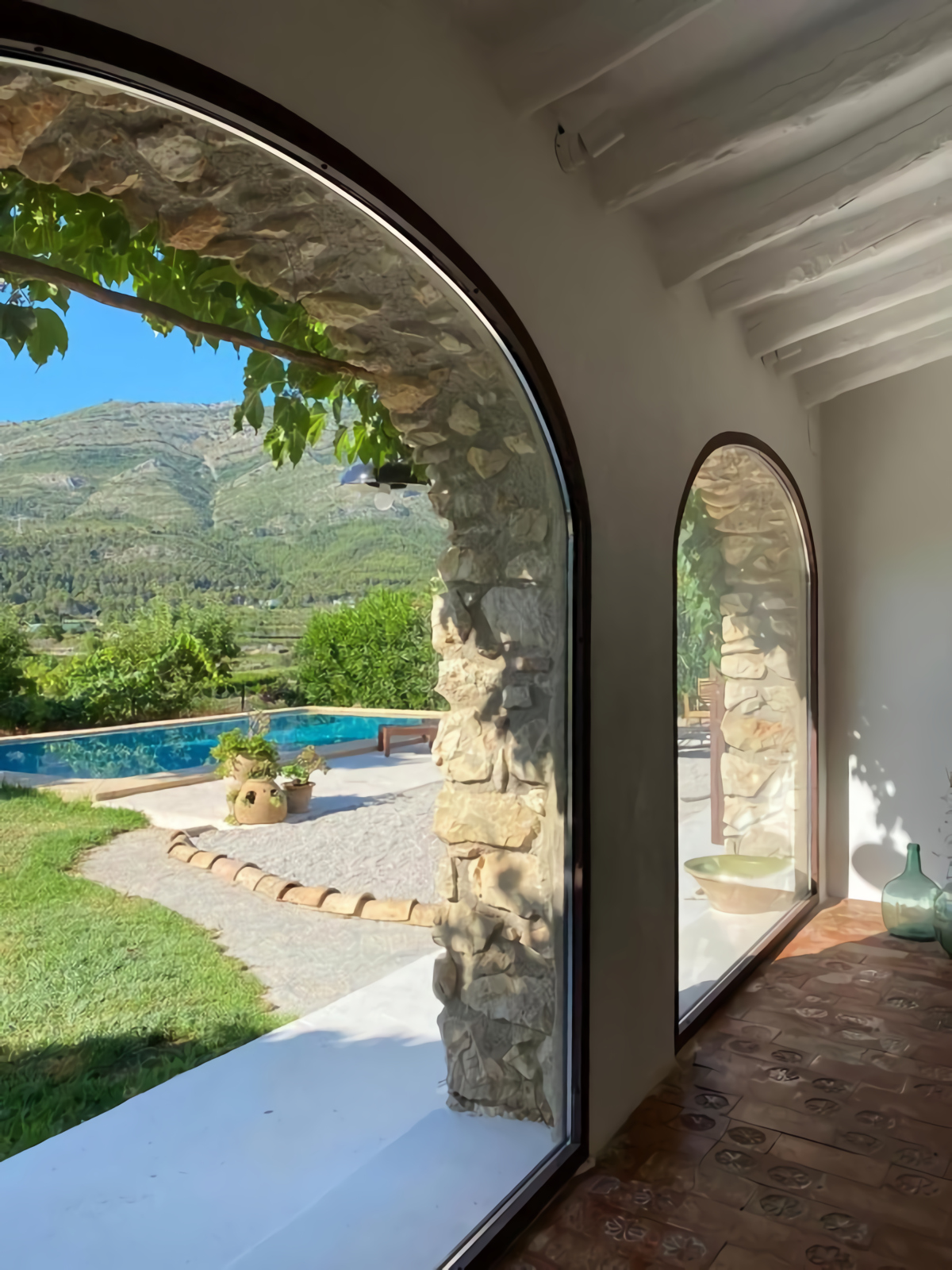 salon avec poutres et arches dans maison en pierres rénovée