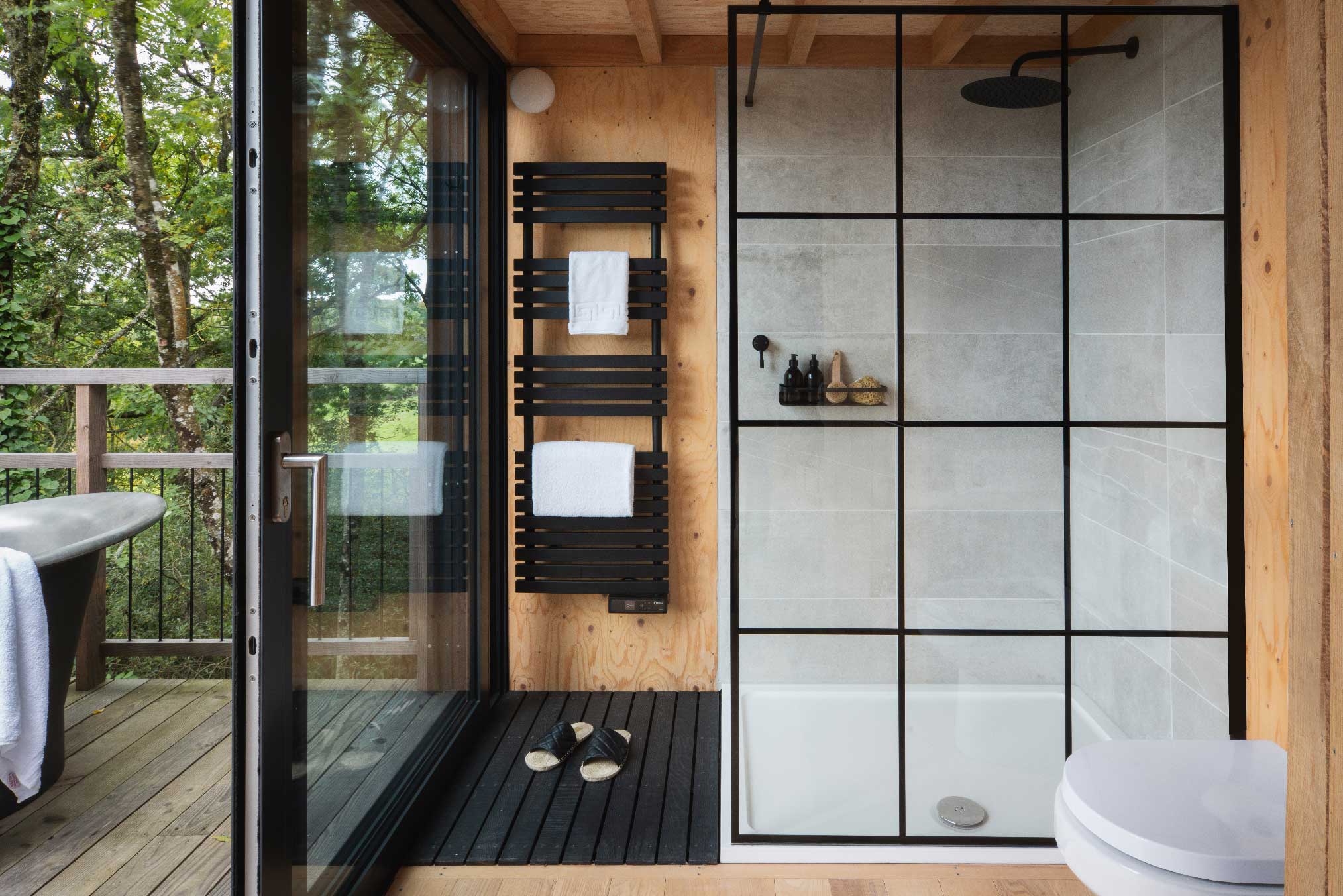 salle de bain design maison en bois noir dans les arbres