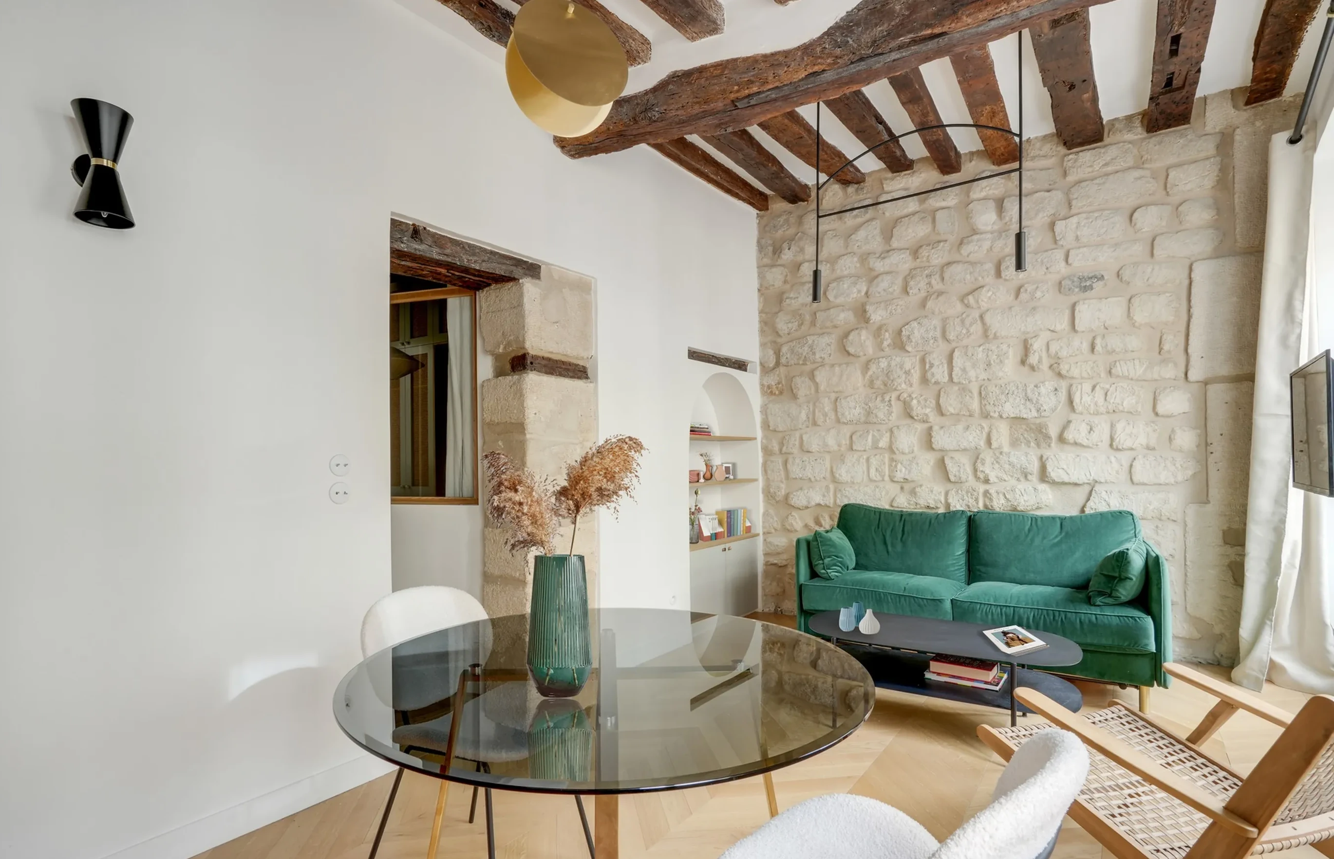 salon avec poutres et mur en pierres