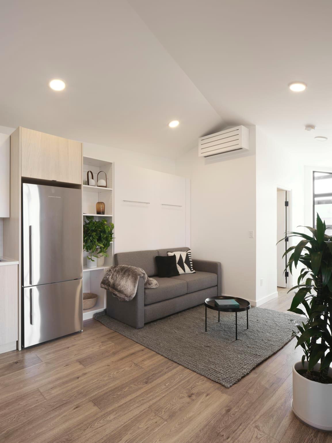 salon avec lit escamotable petite maison 32m2 préfabriquée