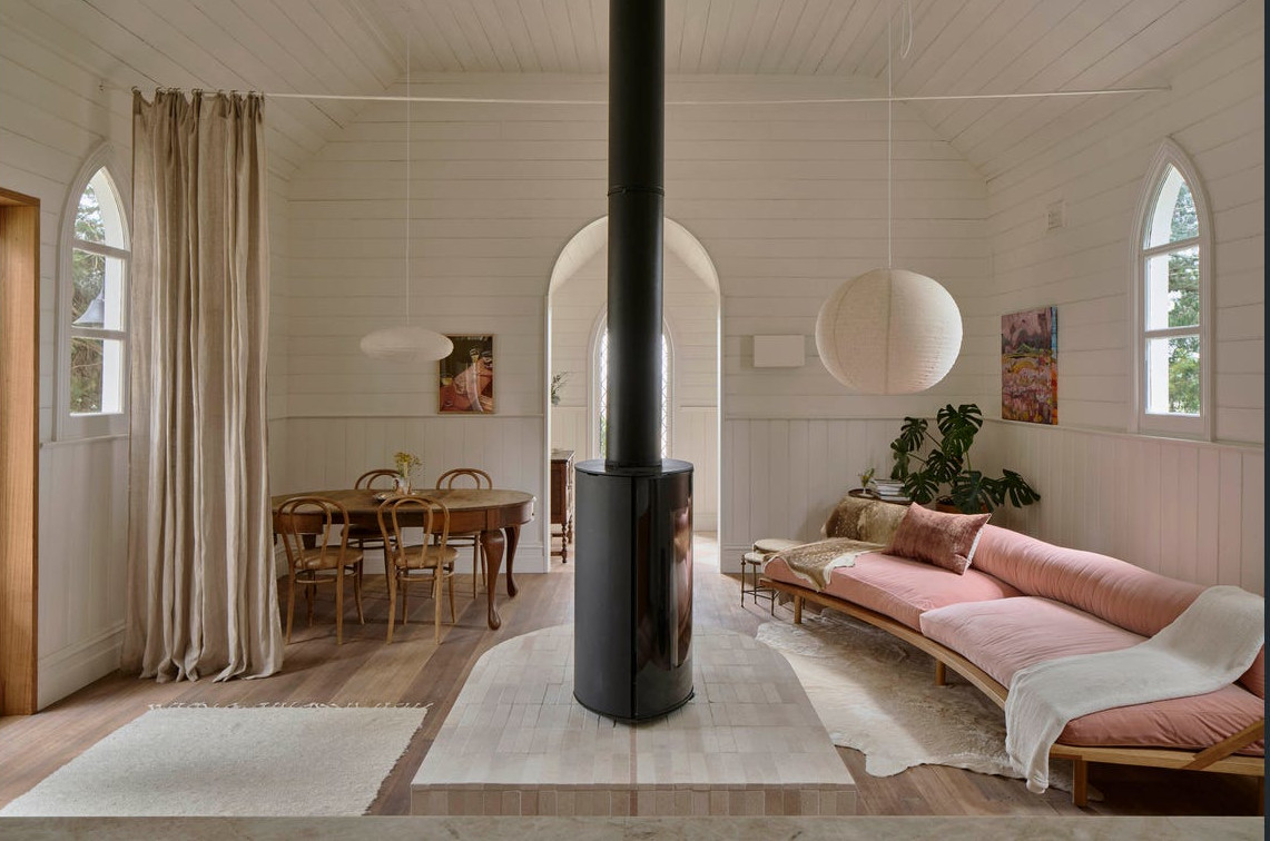 designer living room with pink sofa and designer fireplace in a contemporary house in a former church with architect designer living room with pink sofa and designer fireplace in a contemporary house in a former church with architect's extension