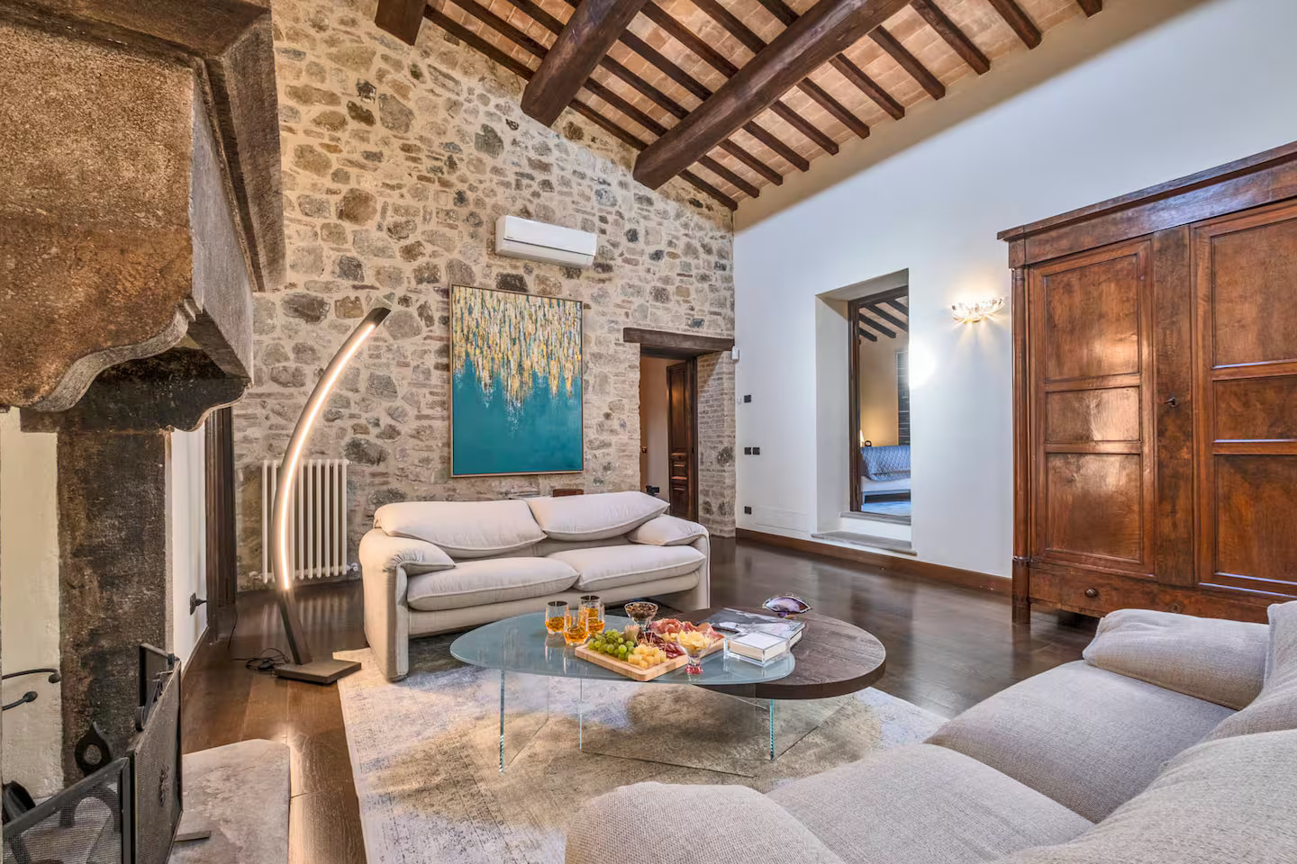 salon avec poutres cheminée et mur pierres maison en pierres Toscane Italie salon avec poutres cheminée et mur pierres maison en pierres Toscane Italie