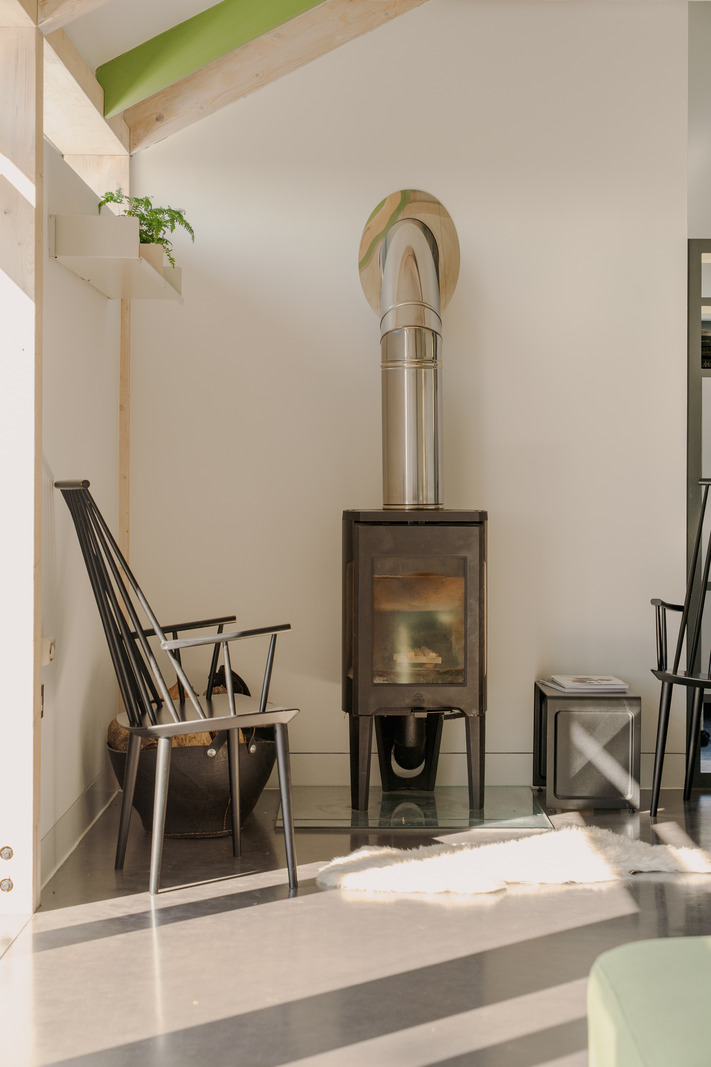 stove in living room concrete floor bay windows contemporary house in Wales "The chicken shed" stove in living room concrete floor bay windows contemporary house in Wales "The chicken shed"