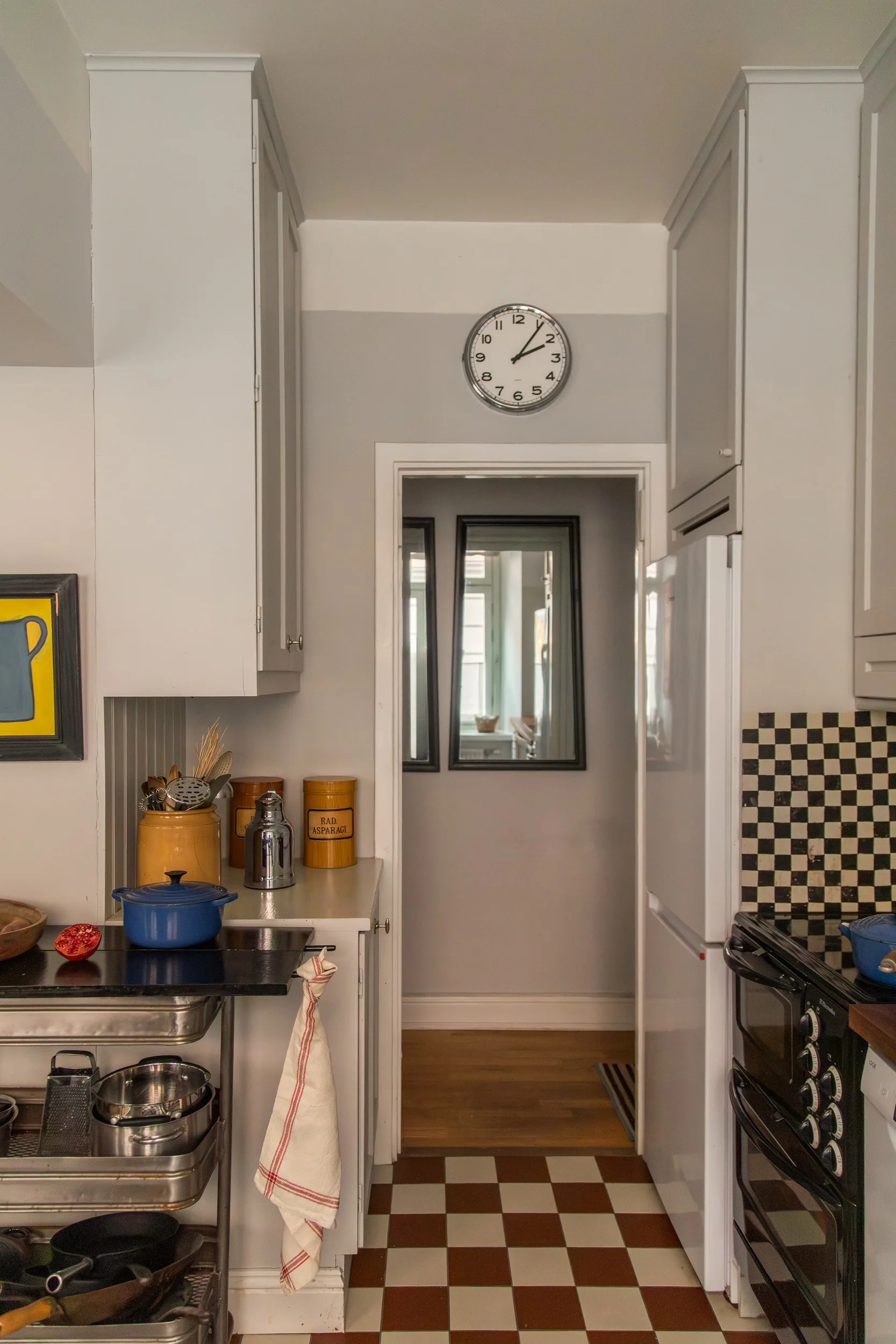 kitchen with checkered red and white floor gray paneled walls vintage decor 55sqm apartment Sweden