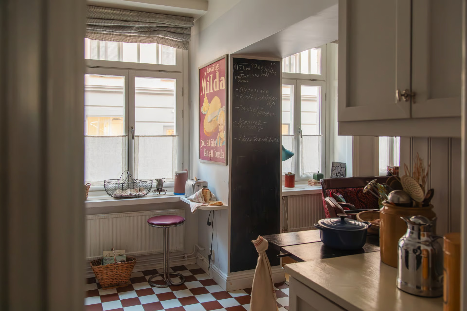 kitchen with checkered red and white floor gray paneled walls vintage decor 55sqm apartment Sweden