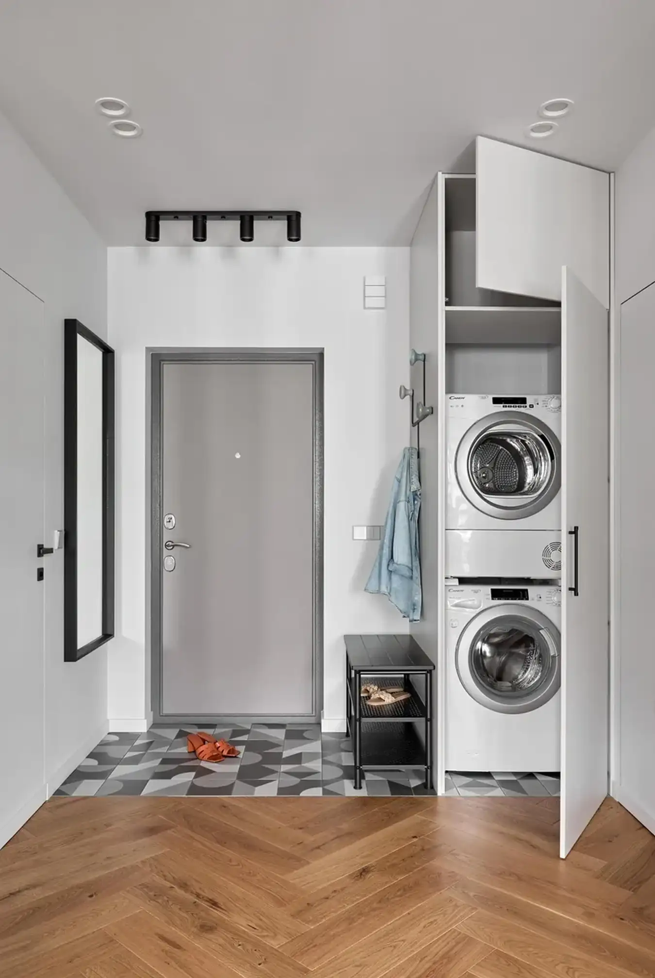 entryway with laundry in a cupboard two-room flat with IKEA furniture
