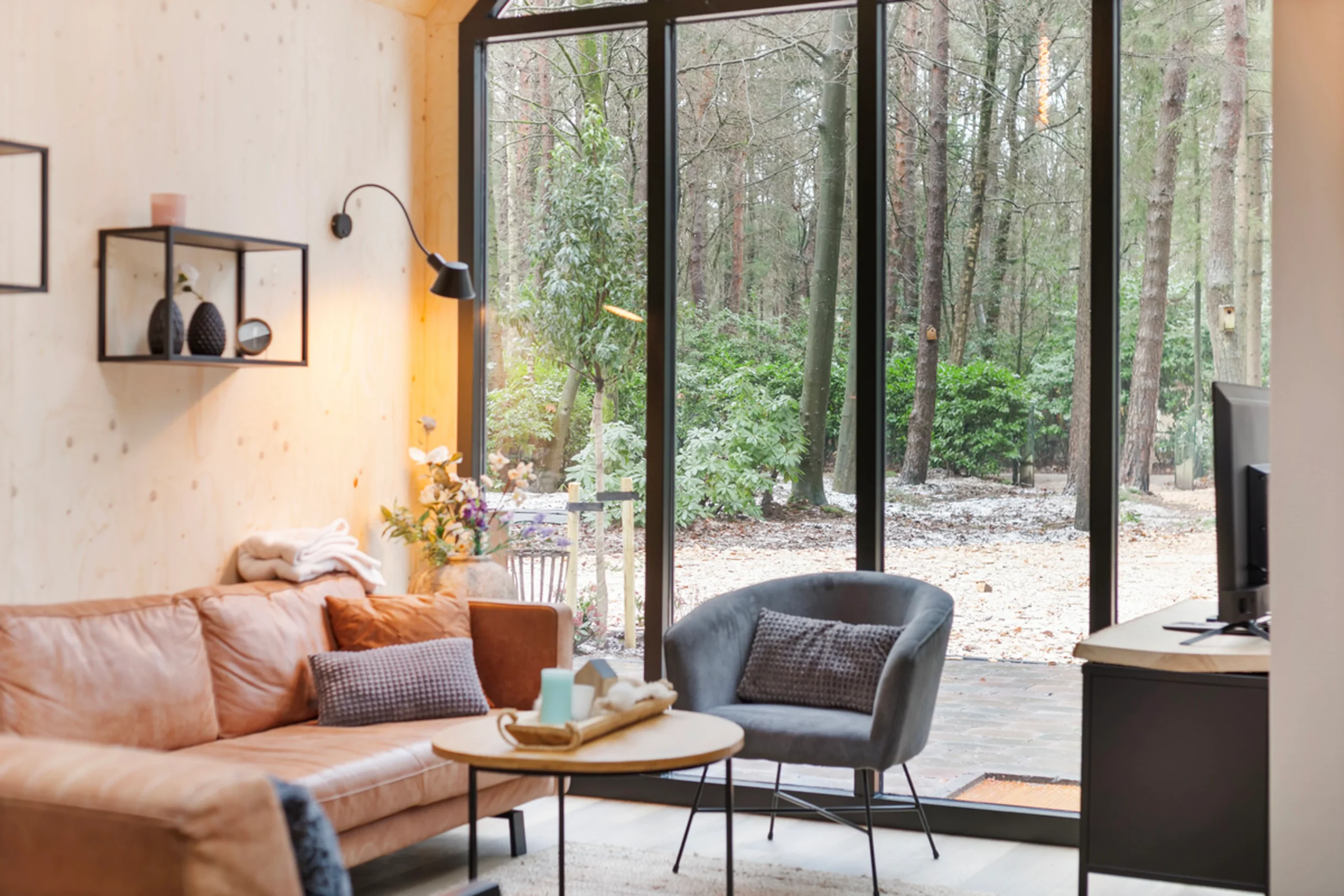 living room with double-height glass gable modern wooden house with lush garden Netherlands living room with double-height glass gable modern wooden house with lush garden Netherlands