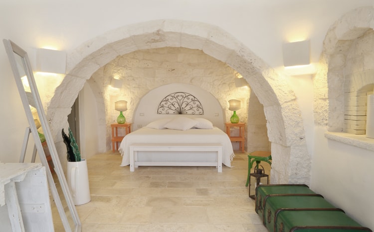 bedroom with archs and stone walls Villa Coki Italy