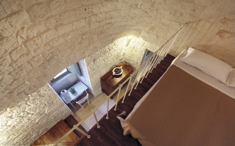 bedroom on mezzanine with stone walls Villa Coki