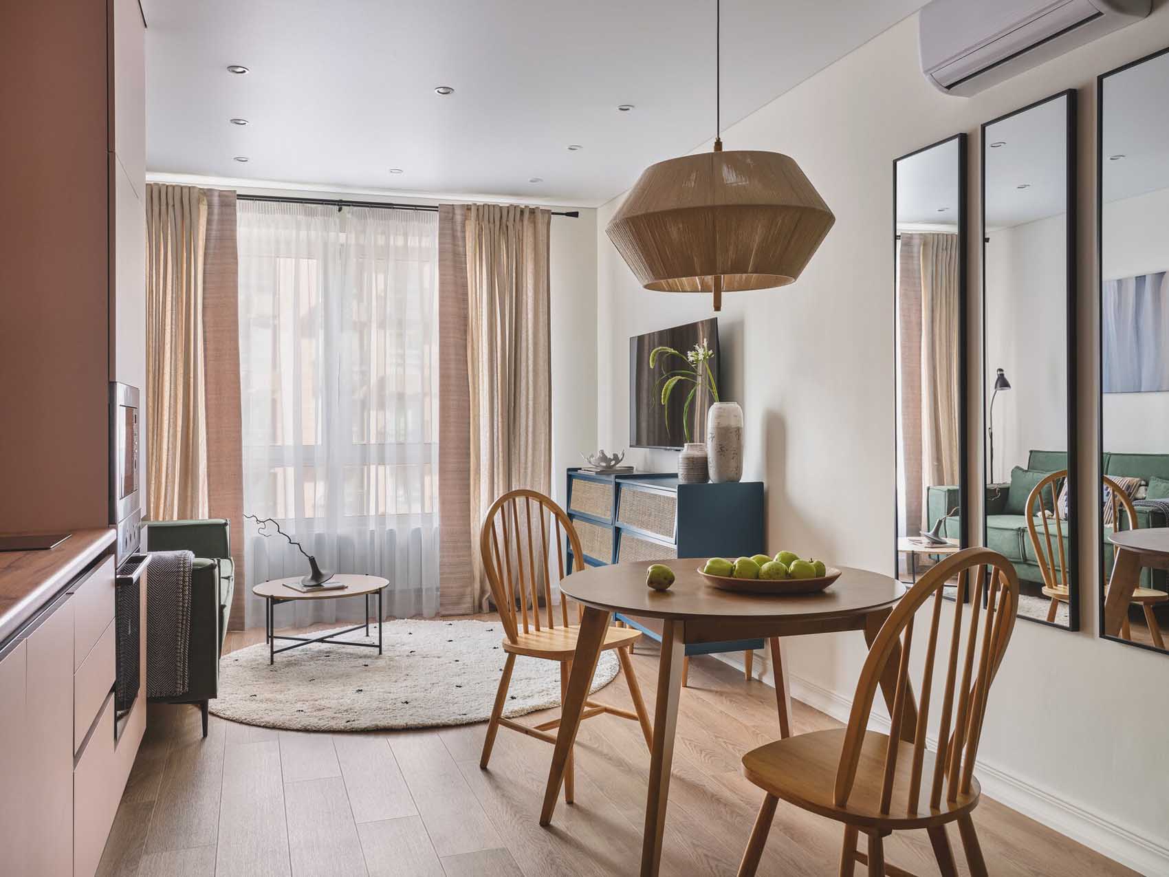 pink kitchen dining room and living room with green sofa in a two-room 42sqm apartment pink kitchen dining room and living room with green sofa in a two-room 42sqm apartment