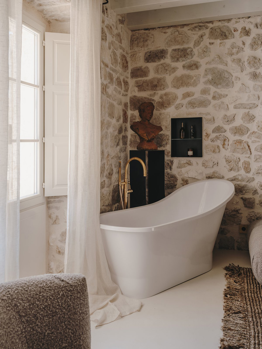 bedroom with stone wall and bathtube Palazzo Caterina Hvar Croatia