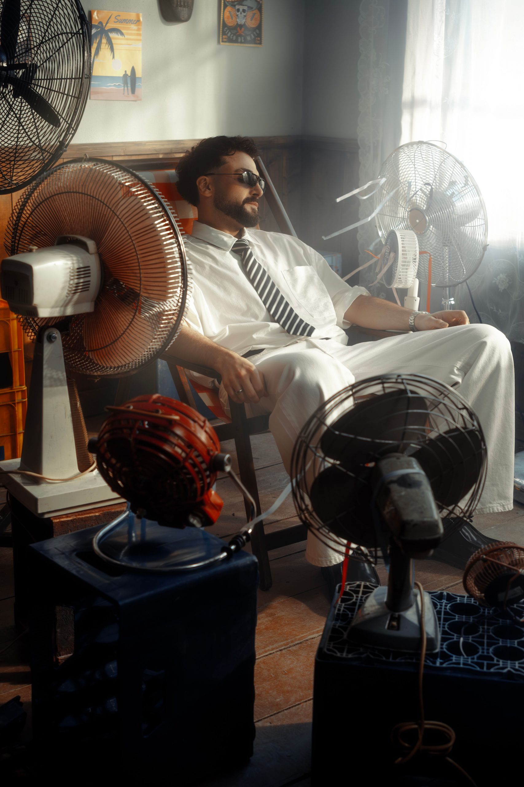 homme dans fauteuil et ventilateur sur pied