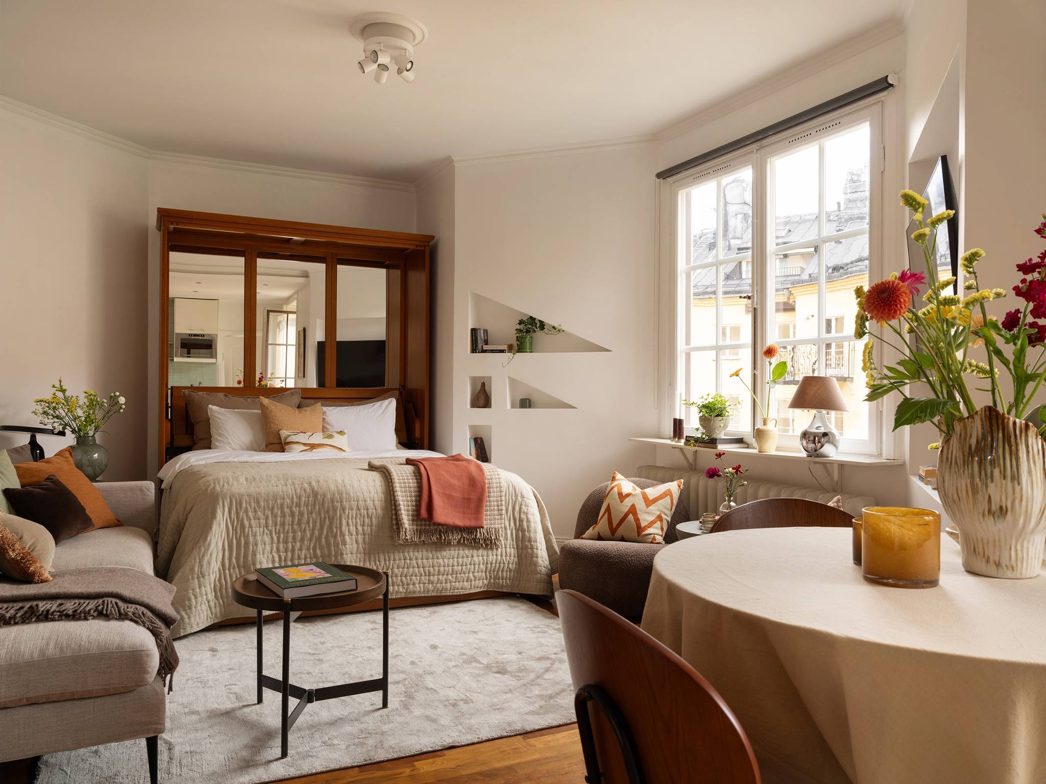 living room with Murphy bed 31sqm studio Scandinavian decor in neutral tons