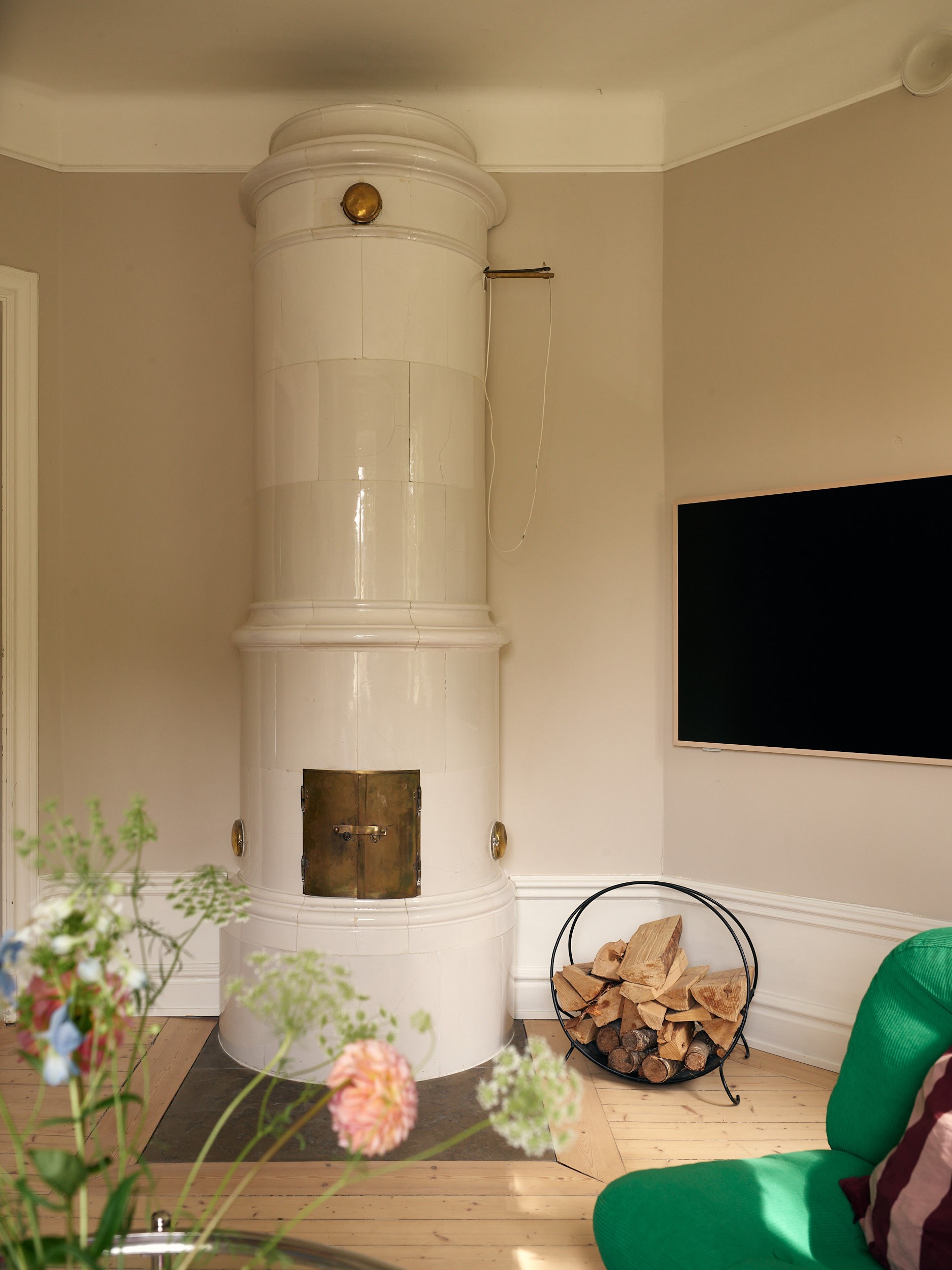 living room with green IKEA vintage armchair and historic stove 58sqm apartment Scandinavian decor living room with green IKEA vintage armchair and historic stove 58sqm apartment Scandinavian decor