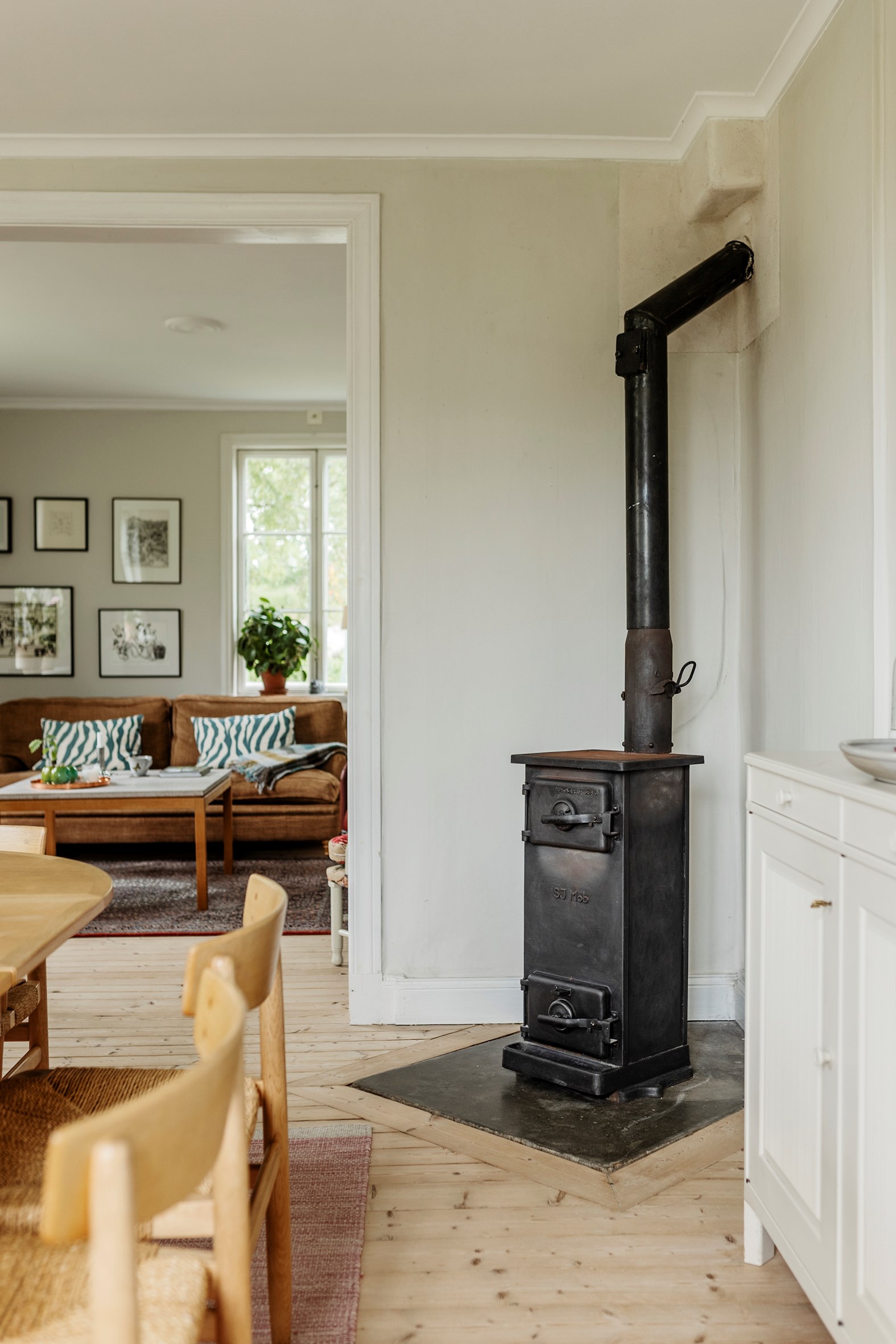salon et salle à manger avec poêle ancien en métal décoration vintage et rustique chic maison en bois jaune Suède