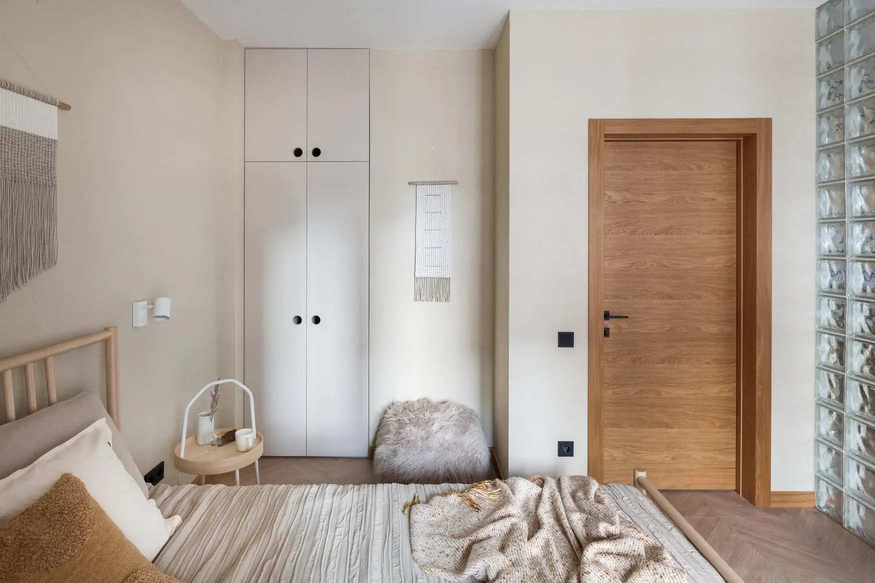 natural bedroom in 45sqm apartment with a glass brick partition