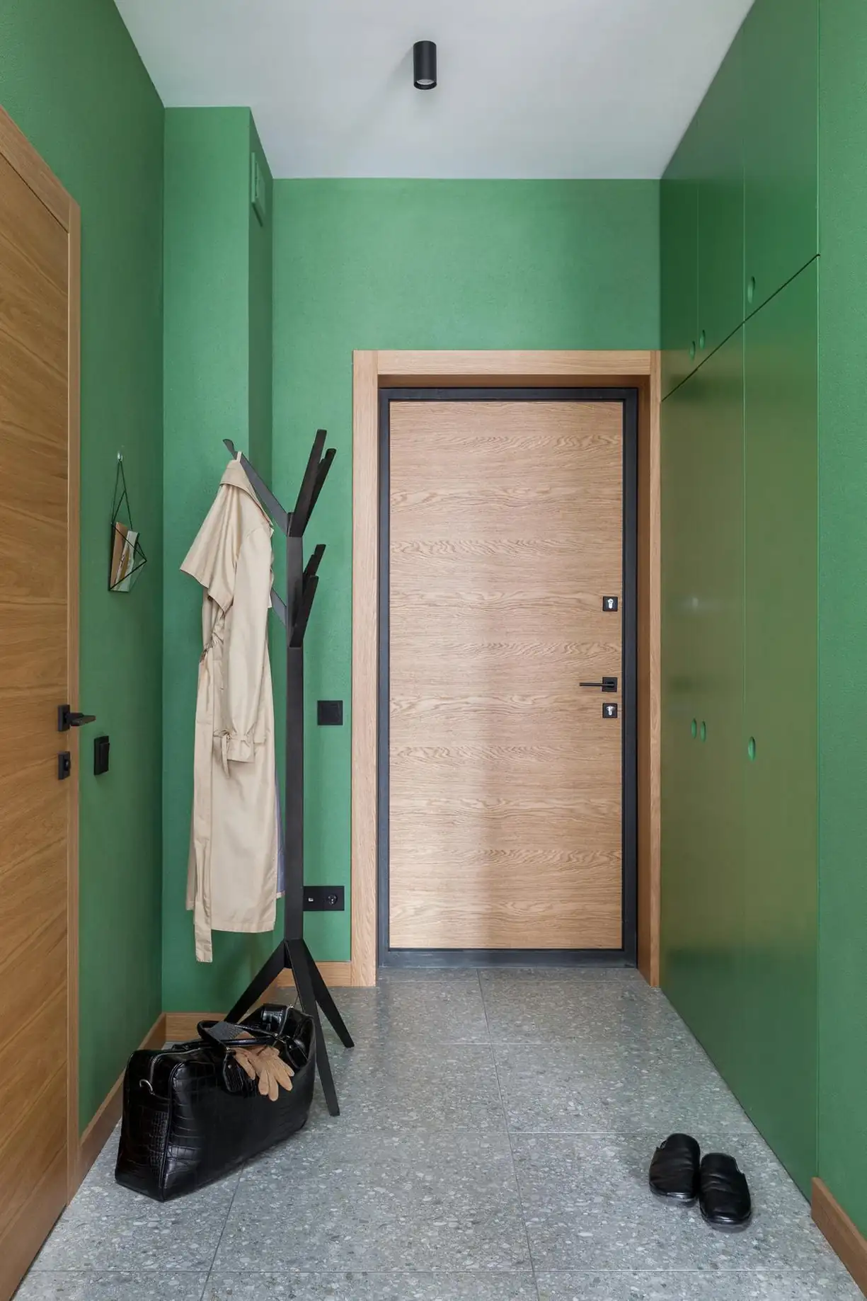 entryway with green walls and terrazzo floor