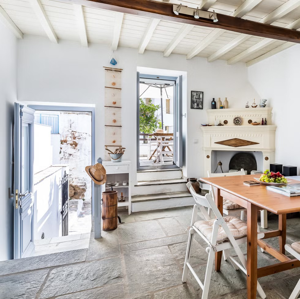 blue and white living room with historic fireplace house in Greece