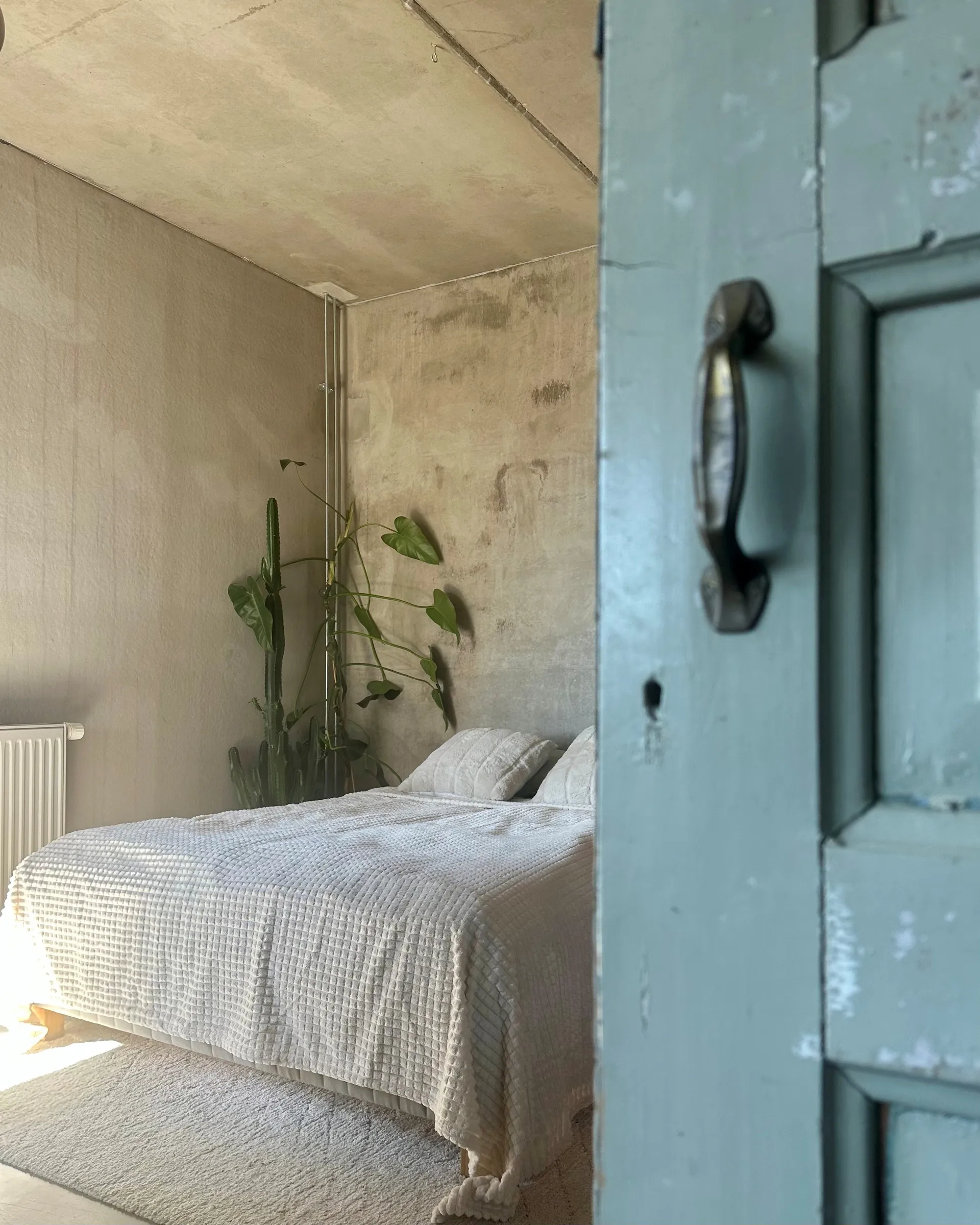 bedroom with concrete floor ceiling and walls