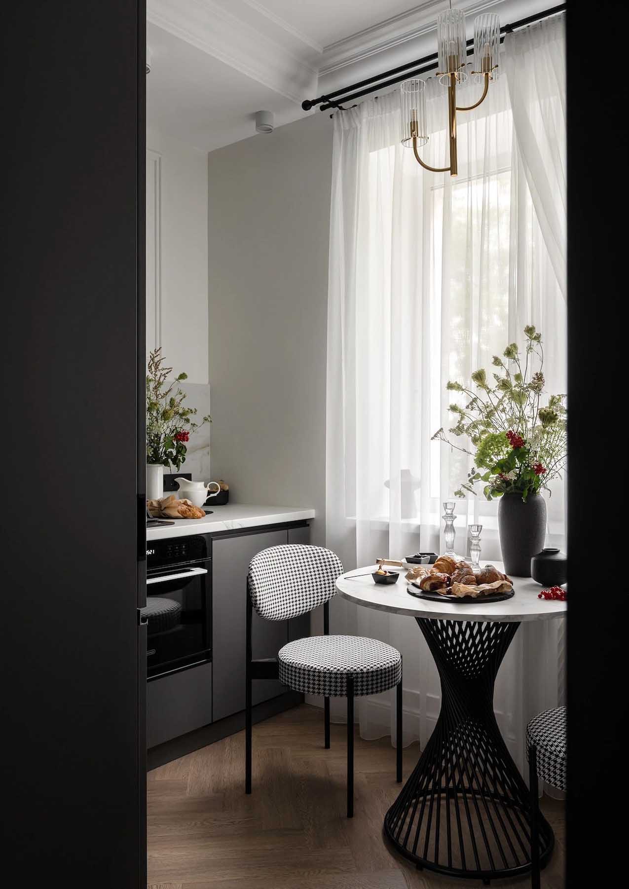 cuisine noire et blanche avec coin repas décoration classique chic appartement 45m2 style Paris Haussmannien cuisine noire et blanche avec coin repas décoration classique chic appartement 45m2 style Paris Haussmannien